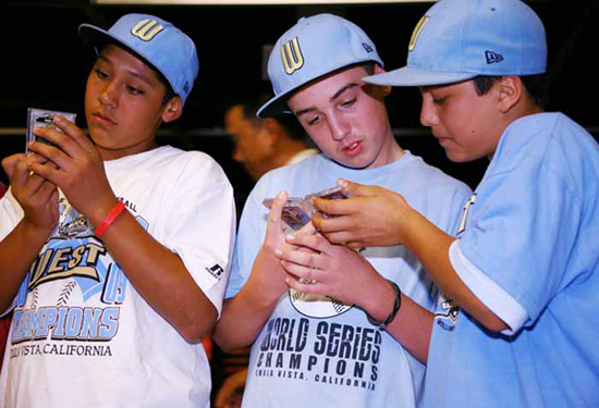 Check-Out-My-Card-4 CHECK THIS OUT: Teammates Andy Rios, Seth Godfrey and Daniel Borras Jr. admire each other’s cards.