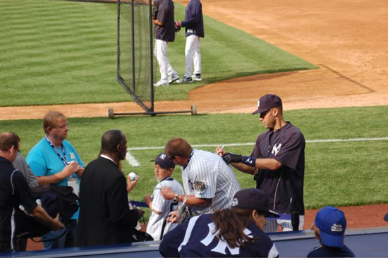 jeter3 Jeter signs Josh Adams’s Yankee jersey on the No. 2.